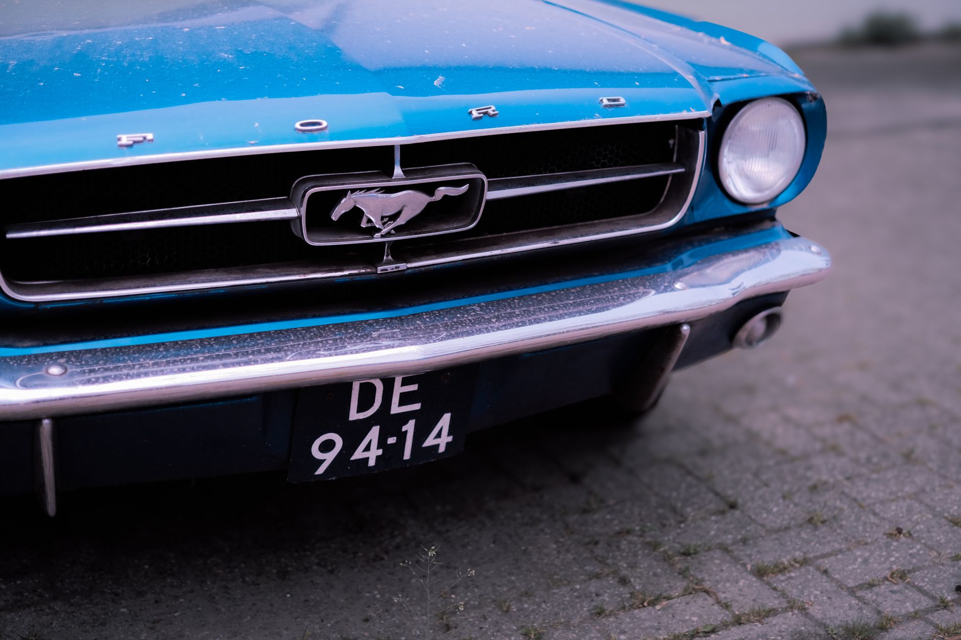 Restored first generation Ford Mustang showcasing classic design and vibrant color.